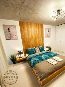 1 dormitorio con 1 cama grande y cabecero de madera en habitat The River Apartment, en Ruse