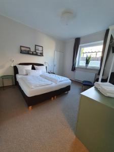 a bedroom with a large bed and a window at Gästehaus bed & kitchen in Schleswig