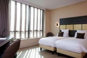 Voodi või voodid majutusasutuse Best Western Plus Hôtel Escapade Senlis toas