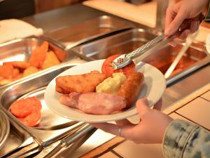 a person holding a plate of food on a counter at The Star Hotel in Southampton