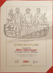 un diploma con disegno di tre persone di Hotel Silberberger - Wildschönau a Oberau