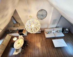 an overhead view of a living room with a clock at Appart4you in Namur