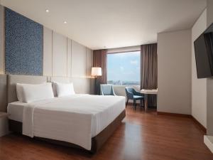 A bed or beds in a room at Hotel Santika Premiere Gubeng Surabaya