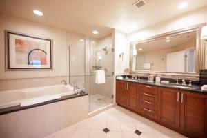 a bathroom with a tub and a sink and a shower at No Resort Fee Strip View Balcony+ Valet Parking in Las Vegas