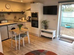 a kitchen with a table and a sink and a stove at The Studio in Harrogate