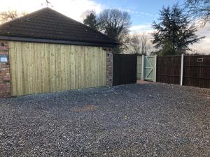 a garage with a gate and a fence at The Studio in Harrogate