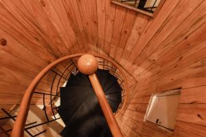 a spiral staircase in a wooden building at Vivera Highlands in Kodaikānāl