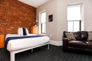 una camera con letto e divano in pelle di Stylish Studio in Boston Brownstone, C.Ave #21 a Boston