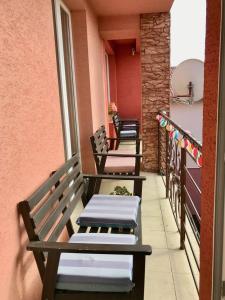 a row of benches sitting on a balcony at Penzión Vilka Podhájčanka in Podhájska