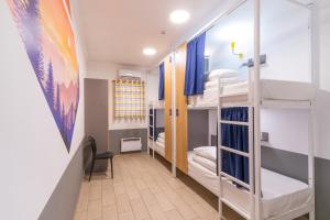 a dorm room with bunk beds and a hallway at ololoFreelander Hostel&Coworking in Bishkek