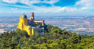 a yellow building on top of a mountain at Santos Mattos Guesthouse & Apartments by Lisbon with Sintra in Amadora