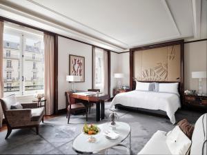 a hotel room with a bed and a desk at The Peninsula Paris in Paris