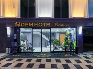 a hotel with tables and chairs in front of a building at Dem Premium Hotel - Round Trip Airport Service - Istanbul International Airport in Arnavutköy