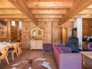 Cabaña de madera con sala de estar con sofá y chimenea en Waldberg, en Krimml