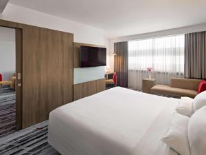 A bed or beds in a room at Novotel Jakarta Gajah Mada