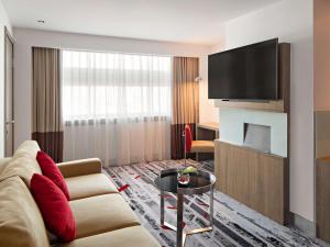 A television and/or entertainment centre at Novotel Jakarta Gajah Mada