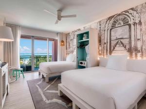 a hotel room with two beds and a window at SLS at Baha Mar in Nassau