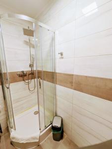 a shower with a glass door in a bathroom at Sea Suite, 150 meters to beach, Baltic Best in Dziwnówek