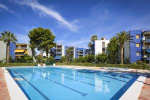 uma grande piscina em frente a alguns edifícios de apartamentos em New Reus Mediterrani em Vilafortuny