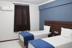 Days inn by Wyndham Uberlândia में एक कमरे में एक या कई बेड