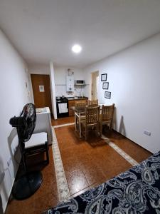 a room with a bed and a table and chairs at Córdoba Te Espera in Cordoba