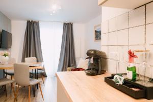 a kitchen and living room with a table and chairs at Black Forest Dream Apartments in Feldberg