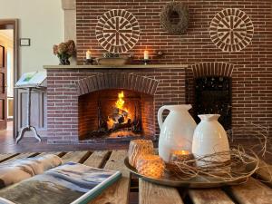 sala de estar con chimenea y mesa con 2 jarrones en Stimbekhof, en Bispingen