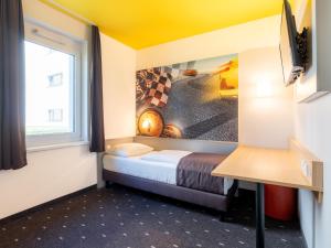 Ένα ή περισσότερα κρεβάτια σε δωμάτιο στο B&B Hotel Stuttgart-Zuffenhausen