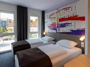 Кровать или кровати в номере B&B HOTEL Bad Hersfeld