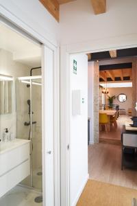 a bathroom with a glass door leading into a living room at Brito Capelo 183 in Matosinhos