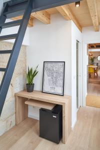 a living room with a desk and a staircase at Brito Capelo 183 in Matosinhos