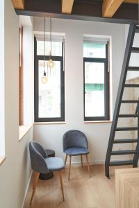 a living room with a chair and a staircase at Brito Capelo 183 in Matosinhos