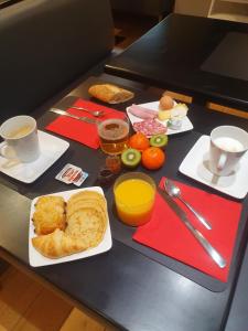 un tavolo con colazione a base di pane, uova e caffè di EtC...Hôtel - Strasbourg Hyper Centre a Strasburgo