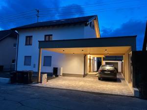 a car parked in a garage next to a house at Lake & Town Apartments Klagenfurt in Klagenfurt