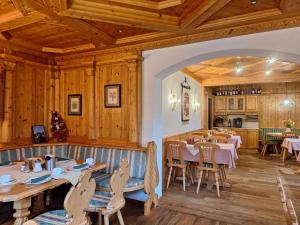 un restaurante con paredes de madera, mesas y sillas en Hotel Stegmühlhof, en Mauterndorf