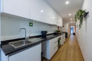 a kitchen with a sink and a counter top at Live in Aveiro in Aveiro