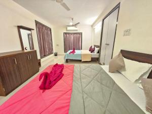 een slaapkamer met een grote roze deken op de vloer bij Seven Villa with Swimming pool in Panchgani