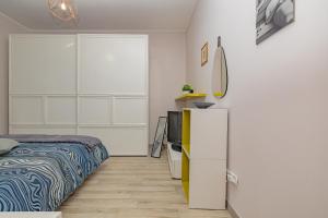 a bedroom with a bed and a television in it at SweetHomeSaronno-A 20 minuti da Milano in Saronno