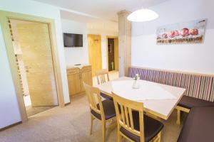 a kitchen and dining room with a table and chairs at Nöglhof in Radstadt