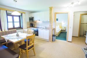 a kitchen and dining room with a table and a dining room at Nöglhof in Radstadt