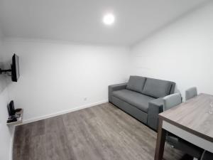 a living room with a couch and a table at Apartment in Semeador in Portalegre