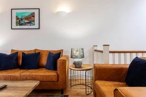 a living room with a couch and a table at Light and airy upside down house in Hackney in London