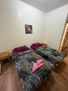 A bed or beds in a room at Hôtel Lyonnais