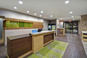 an office with a reception desk and a library at Home2 Suites By Hilton Frankfort in Frankfort