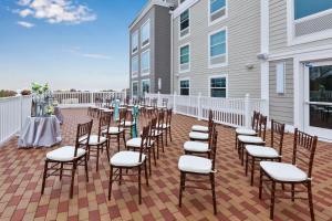 a row of chairs and tables on a patio at Hampton Inn Cape Cod Canal in Buzzards Bay