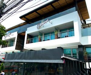 a white building with a sign on top of it at Zi One Luxury Hotel in Pereira