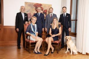 un groupe de personnes posant une photo avec un chien dans l'établissement Hotel Gollner, à Graz