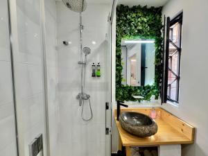 a bathroom with a sink and a shower with a mirror at LOFT CENTRE SANTANDER in Santander