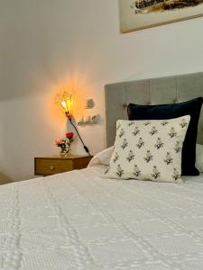 a bedroom with a bed with a pillow and a lamp at LOFT CENTRE SANTANDER in Santander