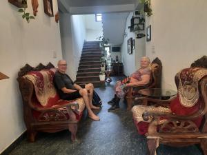 a group of people sitting in chairs in a room at Sopanam Heritage Thekkady in Thekkady